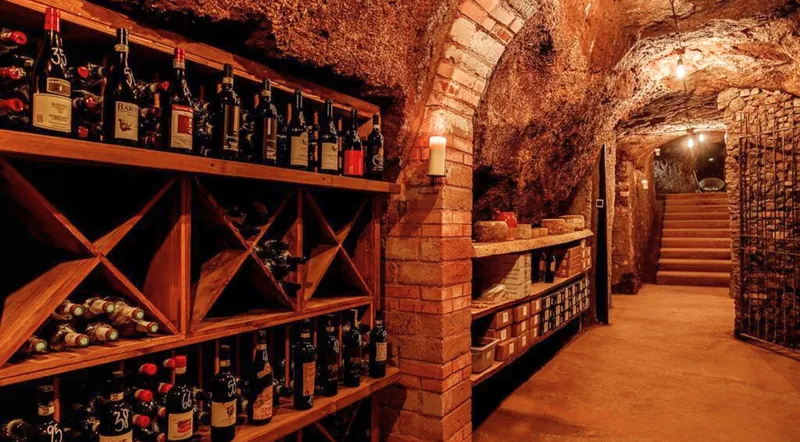 Brick arches and wooden wine racks in an underground cellar in Rome