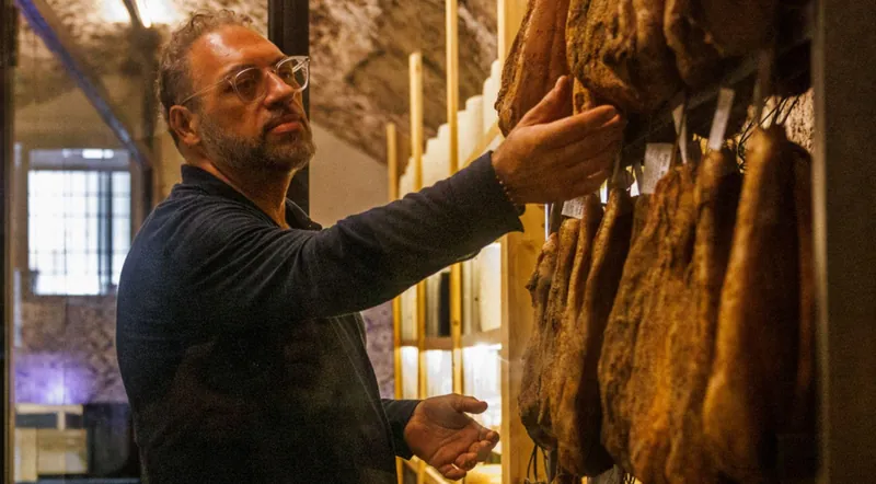 Hams hanging to age in the underground cave at Testaccio