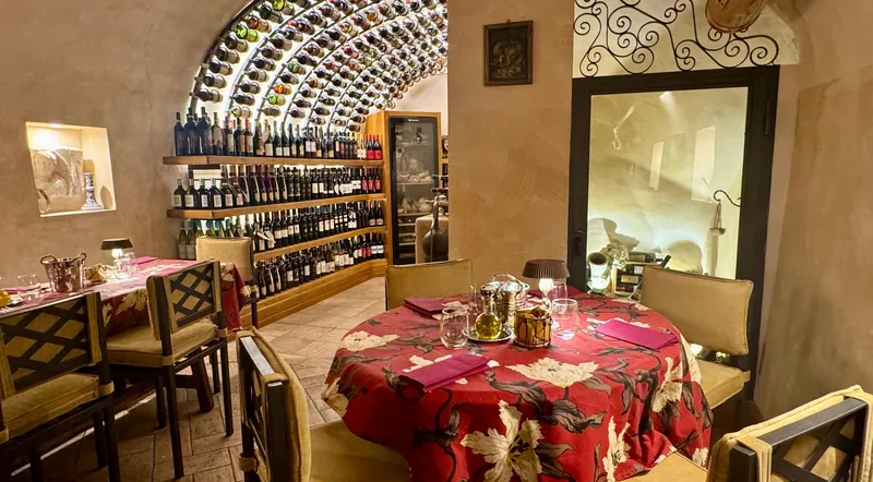 Tables laid for a tasting beneath an arched ceiling of wine bottles in a Trastevere cellar