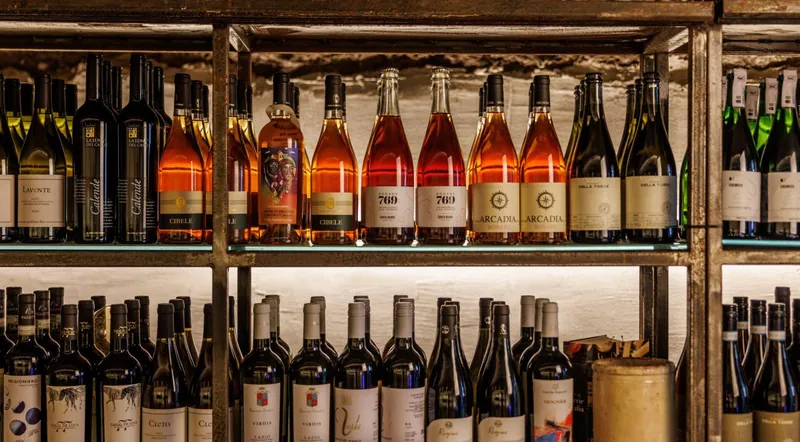 Shelves of Lazio wines, rose and sparkling bottles in the Testaccio cave