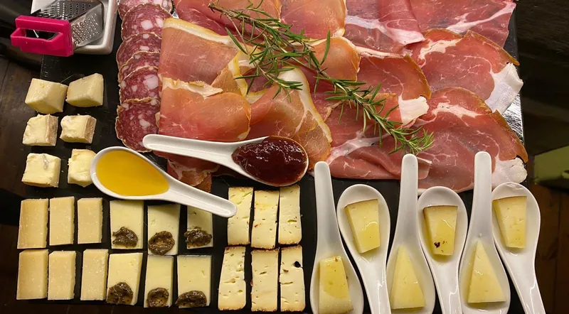 A board of prosciutto, cheeses, truffle and olive oil spoons for a Rome food and wine tasting